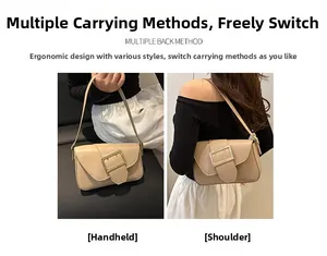 Detail view of a beige shoulder bag with a bold gold buckle and adjustable strap