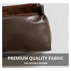 Detail of dark brown tote showing premium smooth faux leather and textured matte suede stitching