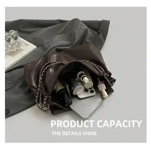 Interior view showing large storage capacity of the dark brown leather tote with chain strap