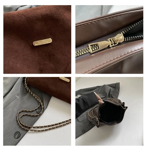 Detail view of brown faux suede bag showing gold hardware, chain strap and interior