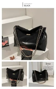 Detail of black patchwork shoulder bag with gold chain strap and suede flap