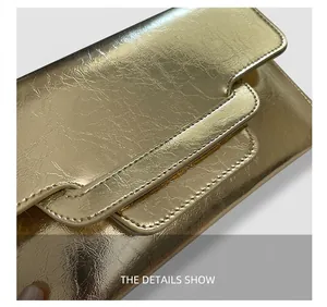 Nahaufnahme der goldfarbenen Metallic-Handtasche mit feiner Rissoptik und Klappenverschluss