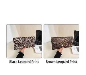 Detail of leopard print envelope clutches in black and brown with heart metal buckles