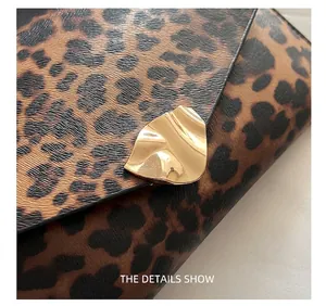Macro view of leopard print leather texture and wavy gold metal buckle detail