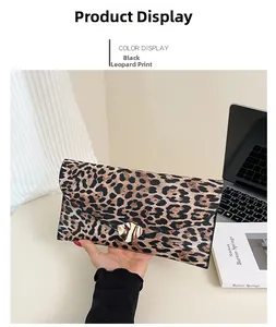 Detail of leopard print envelope clutch featuring a geometric gold metal buckle