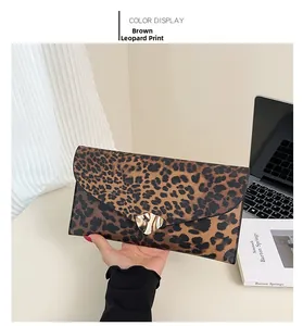 Detailed view of leopard print envelope clutch with heart shaped gold metal clasp