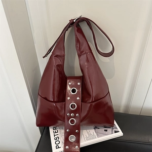 Retro burgundy patent leather hobo bag with silver rivets and metal eyelets