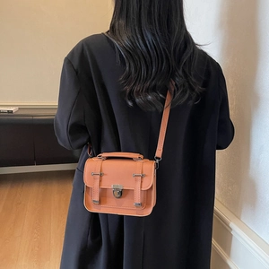 Classic orange brown mini satchel bag with shoulder strap and metal buckle closure