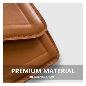 Close-up of caramel brown handbag with pebble grain leather texture and neat stitching