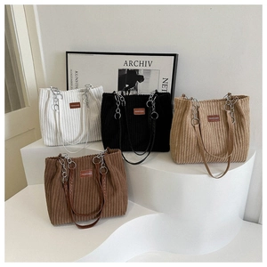 Collection of corduroy tote bags in white, black, beige, and coffee with metal chains