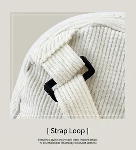 Macro shot of durable white corduroy bag showing strap connection and black buckle