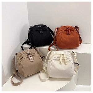 Detailed corduroy texture and dual-zipper design of shell bags in four stylish colors