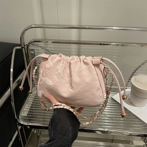 Pale pink cloud shaped crossbody bag with pleated marble texture and metal chain strap