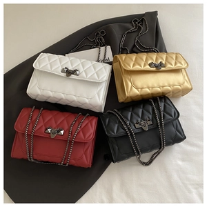 Detail of quilted shoulder bags in four colors with rivet studs and chain straps