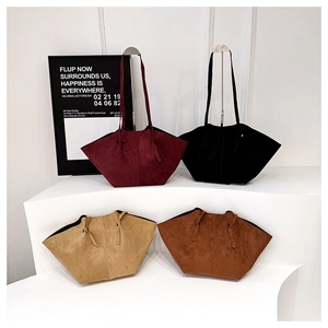 Detail view of large matte leather tote bags in burgundy, black, beige and brown