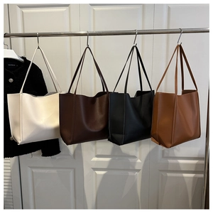 Detail view of large capacity PU leather tote bags in off-white, dark coffee, and black