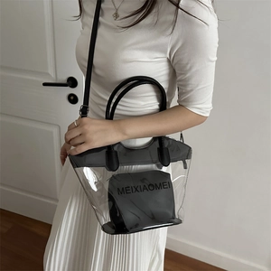 Minimalist transparent PVC bucket tote bag with black inner pouch and adjustable strap