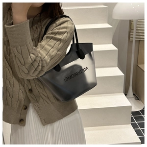 Detail of translucent grey tote bag with black inner pouch and matching handles