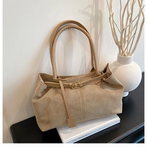 Detail view of large taupe matte faux suede tote bag with stylish buckle strap design