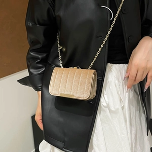 Elegant champagne velvet crossbody bag with vertical stitching and gold chain strap