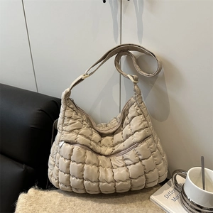 Fashionable quilted puffer tote bag in beige with adjustable strap for urban casual style