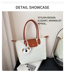 Détail du sac cabas en nylon blanc avec anses en cuir marron et pendentif en peluche