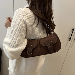 Brown suede baguette bag with vintage buckles and metal chain strap shown on model