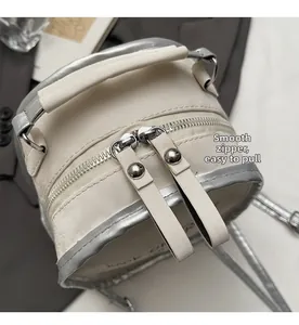 Detail of smooth silver double zippers on elegant white PU leather backpack