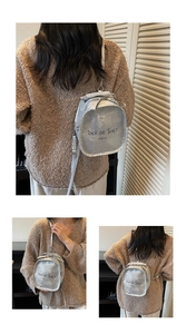 Close-up of metallic silver mini backpack with Trick OR TREAT text and metal zipper detail
