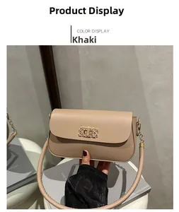 Detail of khaki leather handbag with gold geometric buckle and metal chain strap