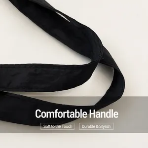 Close-up of durable reinforced double-stitched nylon handles on a black mommy tote bag