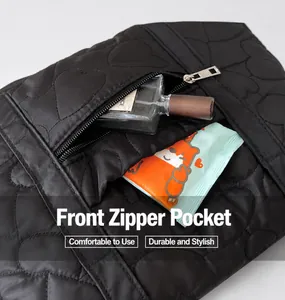 Detail view of heart-quilted fabric with a functional front zipper pocket for storage