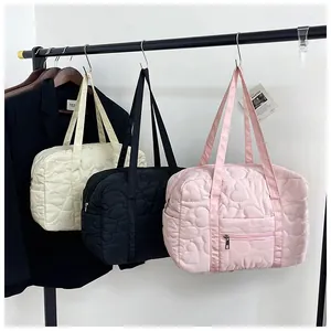 Detailed heart quilted stitching and zipper pocket on pink, white, and black tote bags