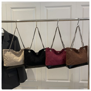Détail de quatre sacs fourre-tout matelassés avec bandoulières en chaîne métallique