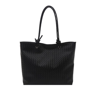 Minimalist black woven tote bag with slim shoulder straps for elegant commute fashion