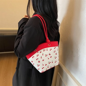 Chic contrast bucket bag with cherry prints and red rope handles for women fashion