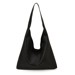 Large black woven shoulder tote bag with minimalist triangular silhouette and long strap