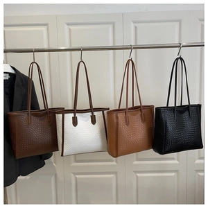 Detailed row of textured tote bags in coffee, cream, tan, and black with faux snake pattern