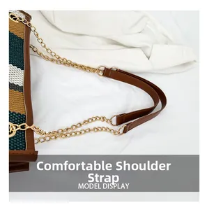 Detail of a retro woven tote bag featuring a gold metal chain and brown leather shoulder strap