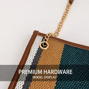 Close-up of retro striped tote bag with premium metal chain strap and leather trim