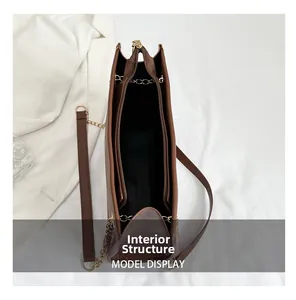 Internal structure of the brown leather tote bag showing double zip and multi-layer design