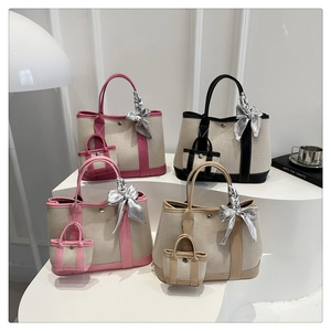 Detailed display of premium canvas garden tote bags with leather trim and silk scarves