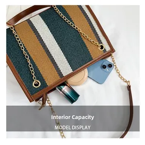 Detail view of striped tote bag interior capacity with leather trim and gold chain