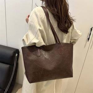 Retro deep brown large tote bag with marble texture shown on shoulder for daily use