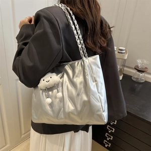 Metallic silver tote bag with textured surface and plush cloud charm for women's daily commute