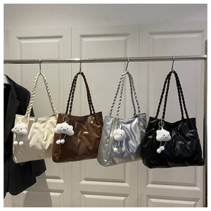 Detailed view of quilted tote bags in four colors with thick woven straps and cloud charms