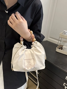 Chic white drawstring handbag with amber marble bead handle and cute bear print