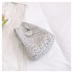 Floral canvas handbag with lace charm and tulip accents in a cozy lifestyle setting