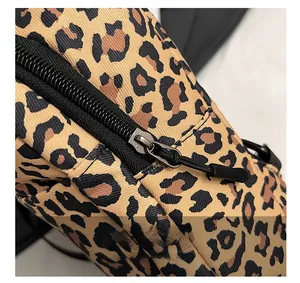 Detail of the leopard print crossbody bag showing the smooth black zipper and puller