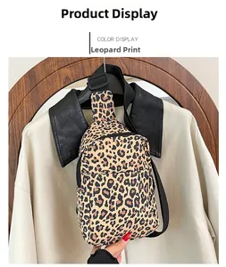 Detail view of leopard print crossbody bag with adjustable black strap and zipper
